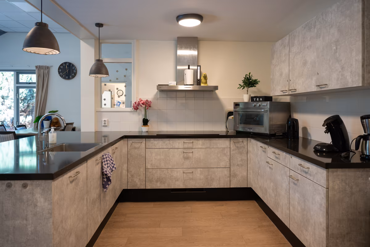 Keuken van Duinrand 25 Gezamenlijke keuken met werkblad en keukenkasten bij Duinrand 25
